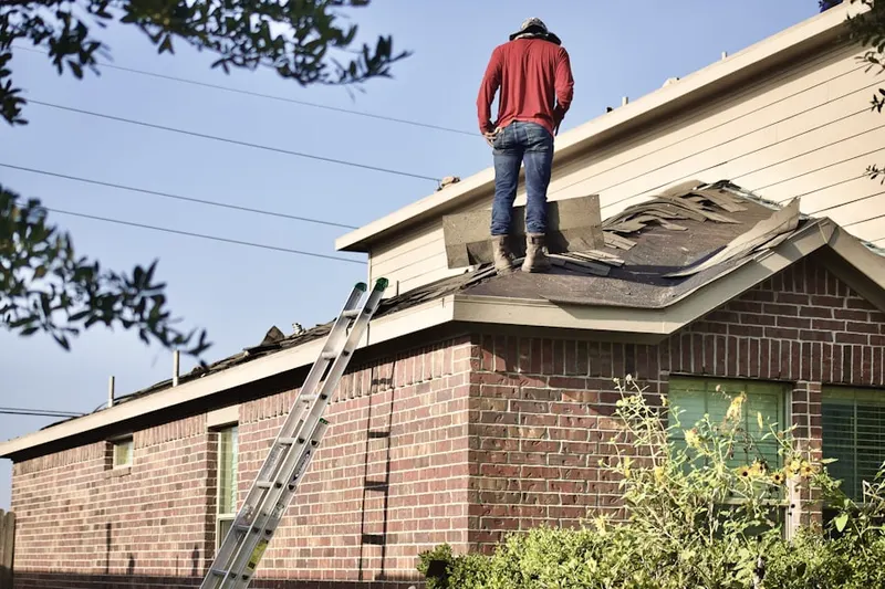 Professional roofer working on a residential roof in Paces Lakes